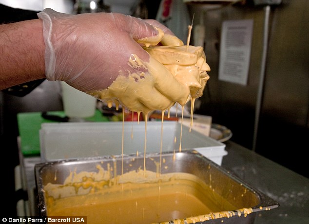 In and out: The breakfast feast is doused in batter before being thrown into the frier (above and below)