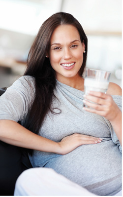 Pregnant woman holding a glass of milk