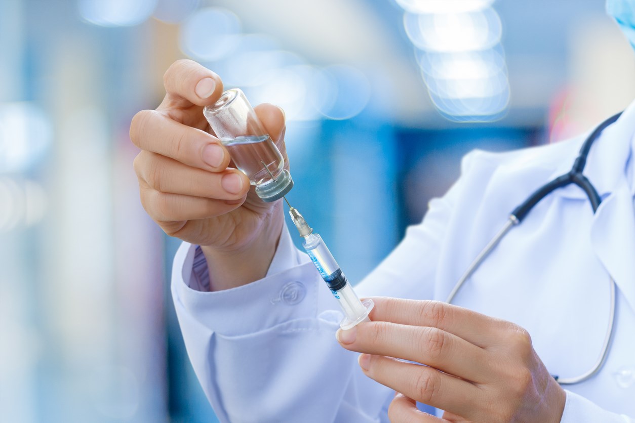 Doctor filling syringe with chickenpox vaccine